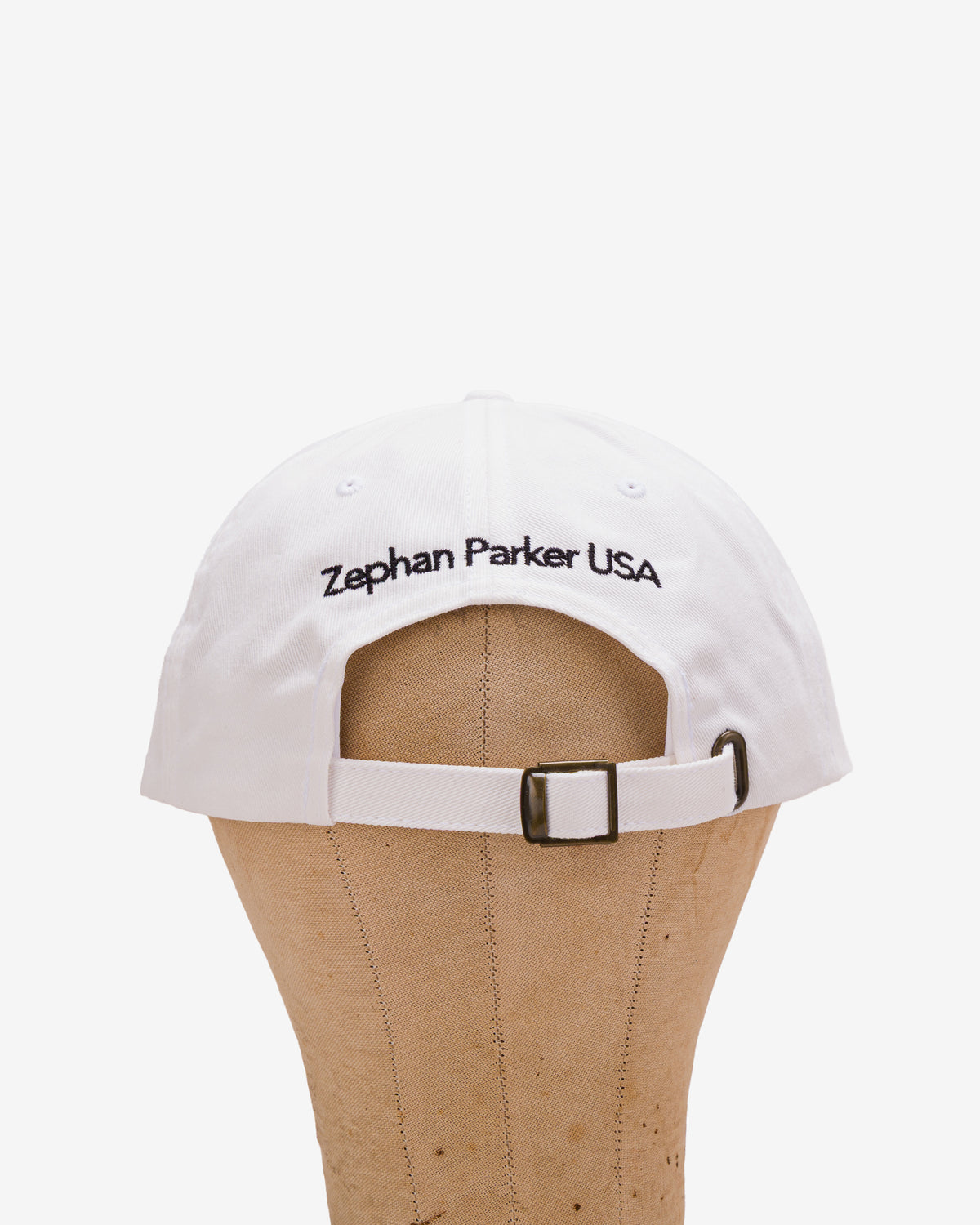 Back of the white Flying Z Ball Cap with black detailing, showing the adjustable closure