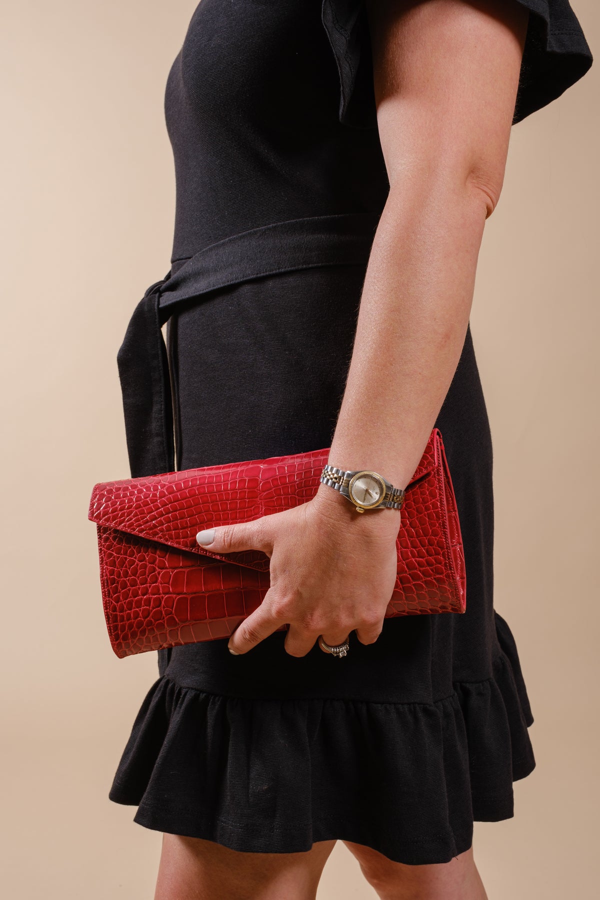 Red alligator leather Catalina clutch carried by hand