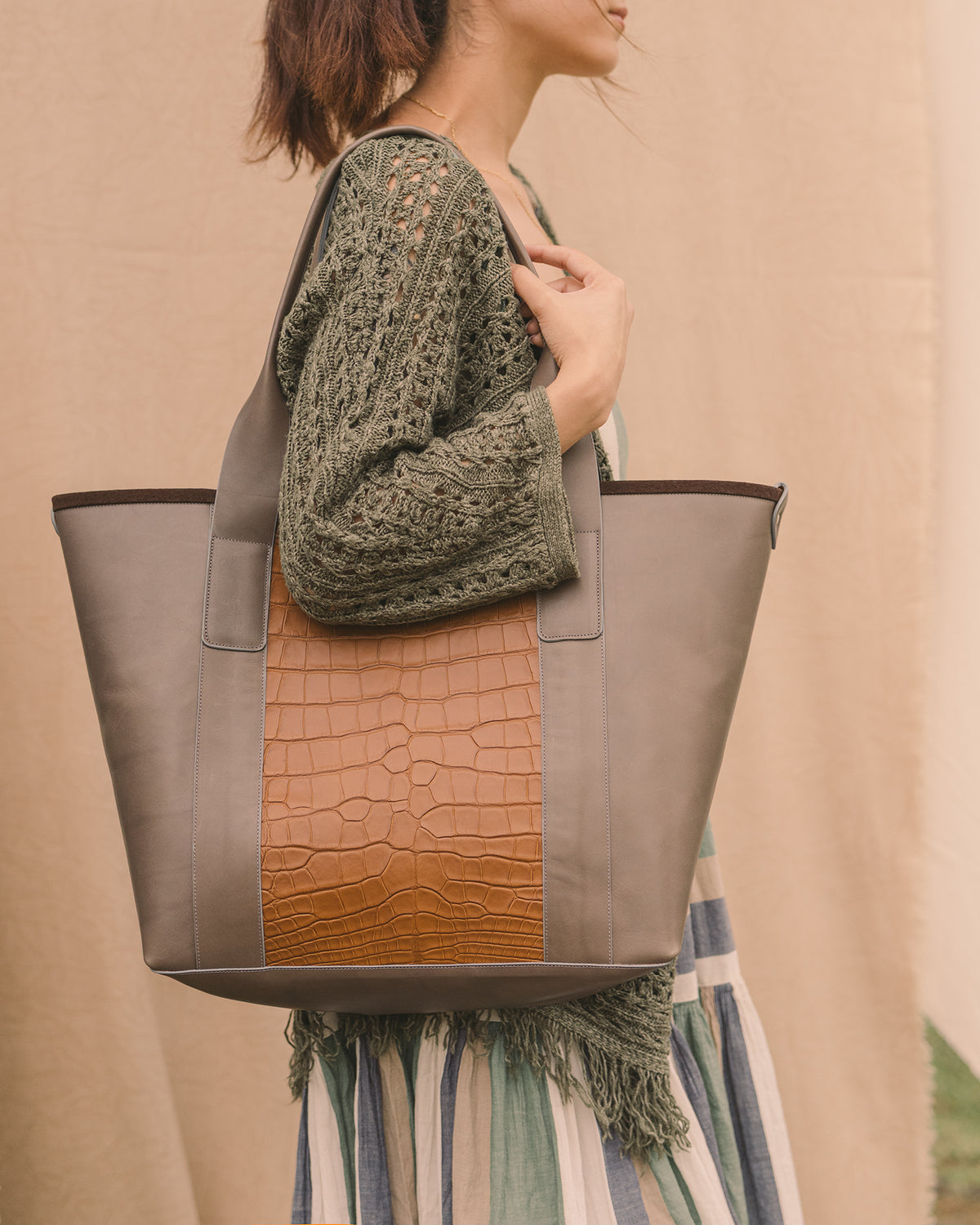 The Pecos Exotic Tote carried on the shoulder, calf leather with alligator accents